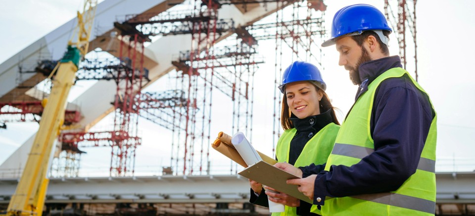 Engineers reviewing plans on site